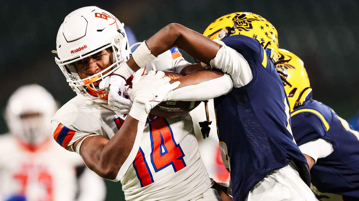 Arlington Bowie running back Denzel Ponder tries to fight off an Arlington Lamar defender while running with the ball Thursday at Choctaw Stadium in Arlington.