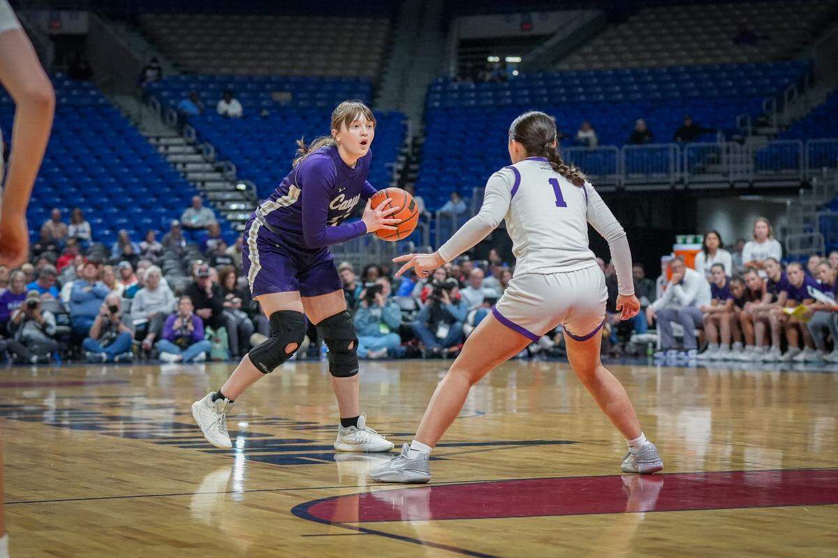 Canyon’s Jaylee Moss (left) eyes one of her record-setting seven three pointers as Jenna Ruede (1) of Boerne tries to defend in a Class 4A state semifinal on Friday, March 1, 2024 at the Alamodome in San Antonio, Texas. Moss was seven of seven from beyond the arc.