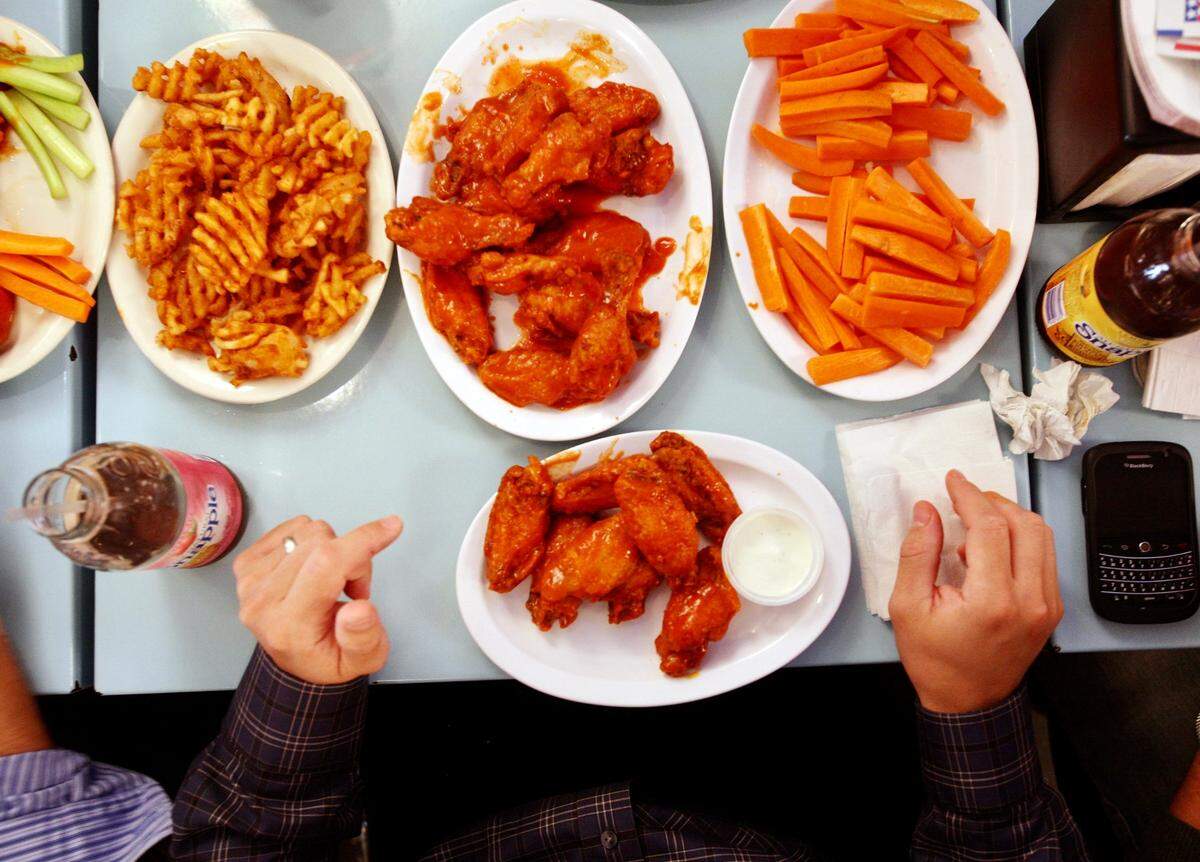 Chicken wings and sides at Atomic Wings in Midtown Manhattan. The restaurant is opening in Arlington.