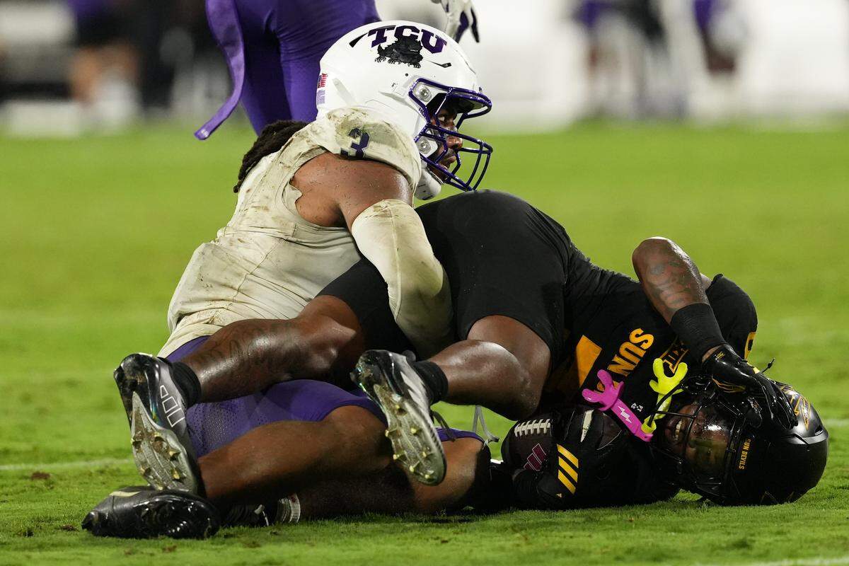 Sep 26, 2025; Tempe, Arizona, USA; TCU Horned Frogs linebacker Kaleb Elarms-Orr (3) tackles Arizona State Sun Devils running back Raleek Brown (3) in the second half at Mountain America Stadium, Home of the ASU Sun Devils. Mandatory Credit: Jacob Reiner-Imagn Images