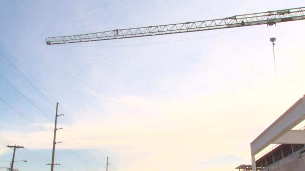 A man possibly in distress was on top of a crane at a construction site in west Dallas on Monday morning, Feb. 13, 2023.