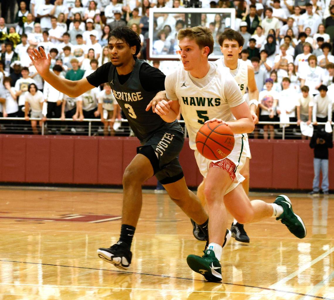 Frisco Heritage guard Mikhail Patel (3) attempts to keep Birdville guard Trent Bowers (5) out of the key during the first half of the UIL 5A state semifinal playoff basketball playoff game at Lewisville High School in Lewisville Texas, Tuesday, Mar. 04, 2025.