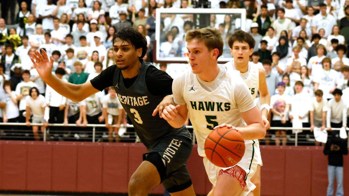Frisco Heritage guard Mikhail Patel (3) attempts to keep Birdville guard Trent Bowers (5) out of the key during the first half of the UIL 5A state semifinal playoff basketball playoff game at Lewisville High School in Lewisville Texas, Tuesday, Mar. 04, 2025.