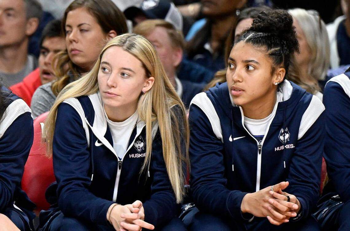 COLLEGE PARK, MARYLAND - DECEMBER 11: Paige Bueckers #5 and Azzi Fudd #35 of the UConn Huskies watch the game against the Maryland Terrapins in the third quarter at Xfinity Center on December 11, 2022 in College Park, Maryland. (Photo by Greg Fiume/Getty Images)