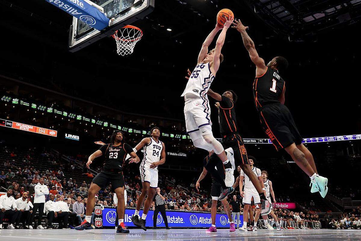 KANSAS CITY, MISSOURI - MARCH 11: Tanner Toolson #55 of the Texas Christian University Horned Frogs drives to the basket as Kanye Clary #1 of the Oklahoma State Cowboys defends during the second round game of the Men's 2026 Big 12 Tournament at T-Mobile Center on March 11, 2026 in Kansas City, Missouri. (Photo by Jamie Squire/Getty Images)
