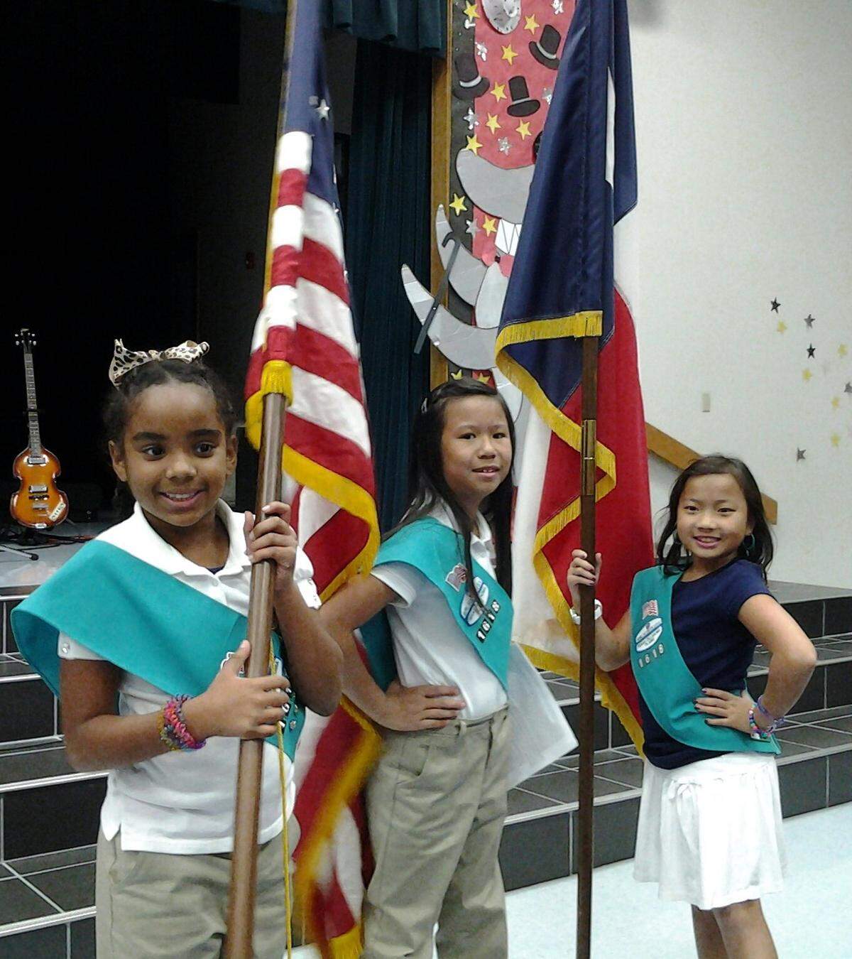 Sept. 11, 2012: Jurney LaJara, left, Jennifer Sparkman and Tiffany Nguyen of Girl Scout’s Troop 1618, getting ready for a flag ceremony at Sherrod Elementary.