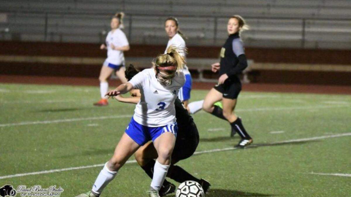 Joshua junior Chloe Walker fights for possession.