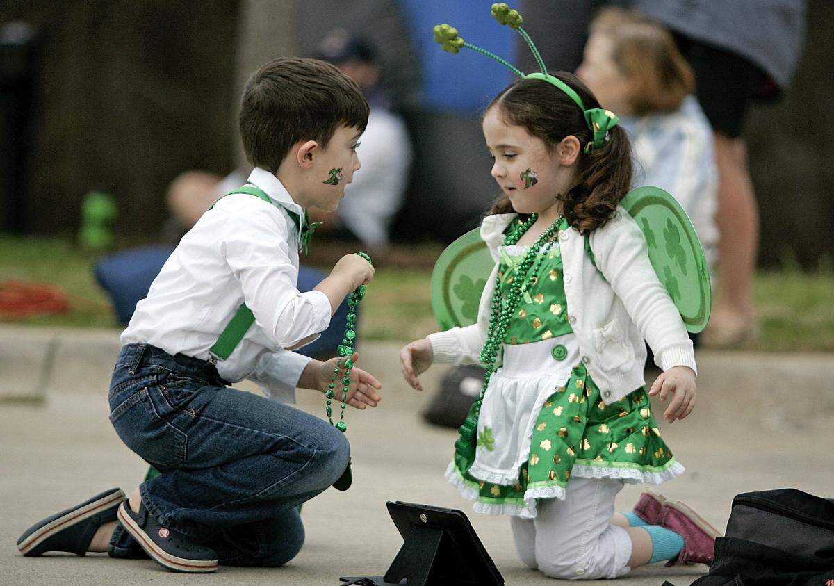 March 15, 2015: Gabriel Seshadri, 6, from Carrollton, gives sister Anna, 4, another St. Patrick’s Day necklace during the St. Pat’s Triathlon in Keller. The race included a 300 meter swim, 12.6 mile bike ride and 3.1 mile run.