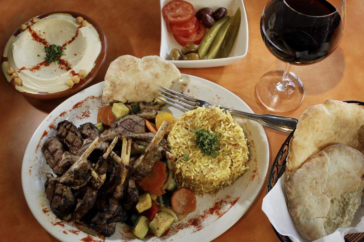 Lamb chops with saffron rice and grilled vegetables and an order of hummus at Terra Mediterranean Grill in 2010.