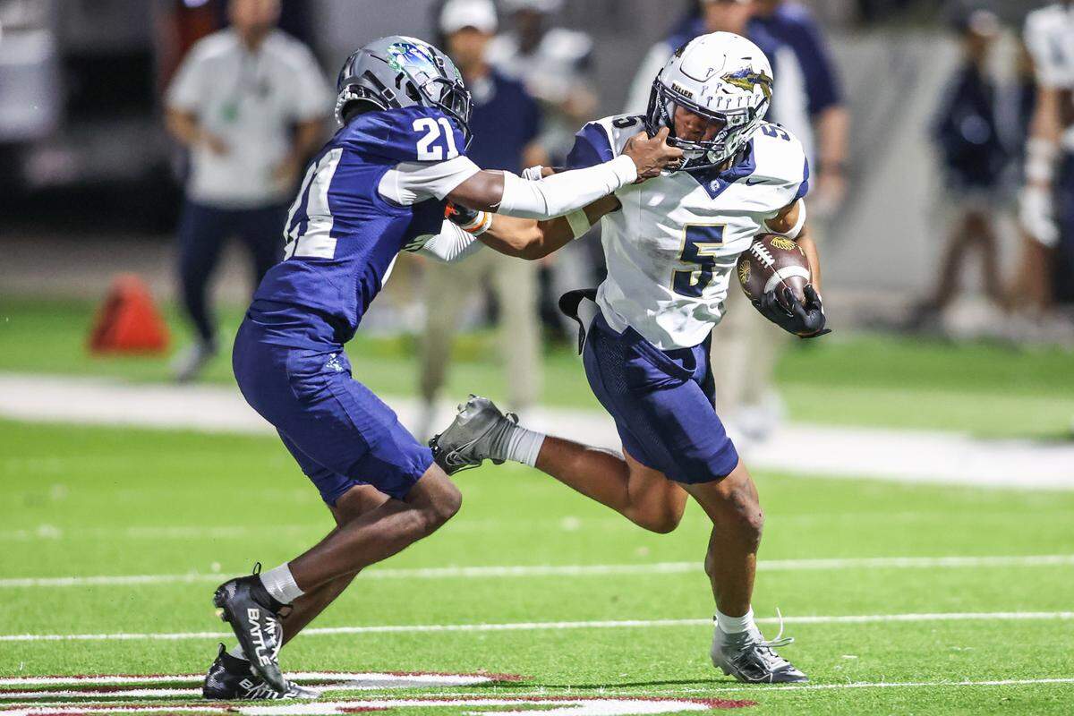 Keller running back Quintin Shropshire (5) has his face mask grabbed by Eaton’s Carl Jones at Northwest ISD Stadium in Justin, Texas, Friday, Nov. 7, 2025.