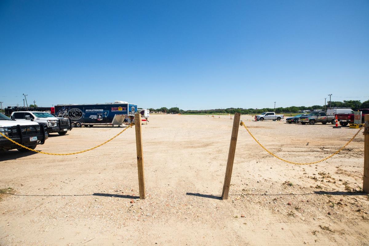 A gravel parking lot with cars and cattle trailers on Friday, June 7, 2024, at the Fort Worth Stockyards, where a major expansion is proposed.
