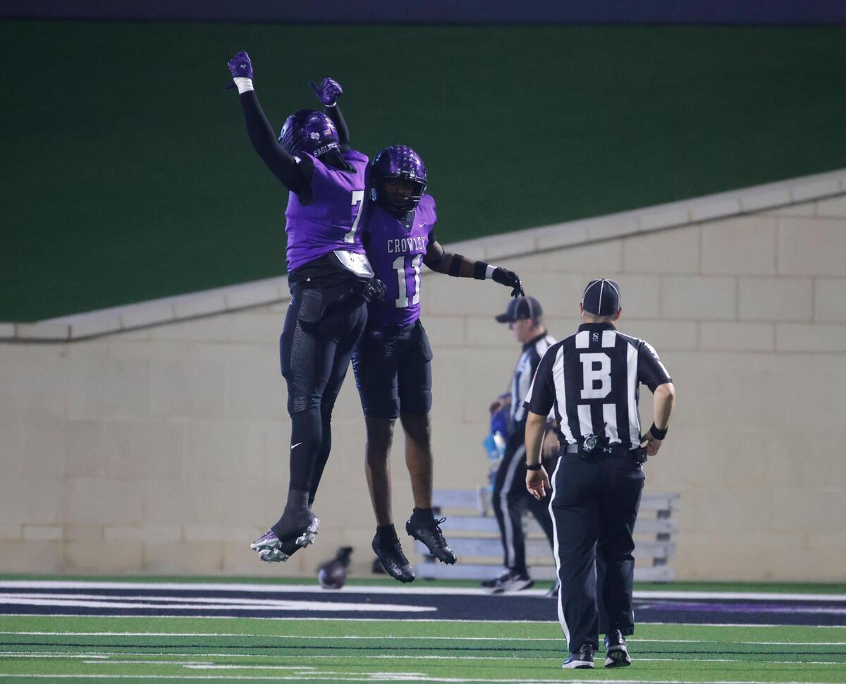 Crowley defensive end Keshawn Morris (7) celebrates with linebacker Kameron Walker (11) after Walker’s scoop-and-score during a UIL District 3-6A football game at Crowley ISD Multi-Purpose Stadium in Fort Worth, Texas, Thursday, Nov. 07, 2024.