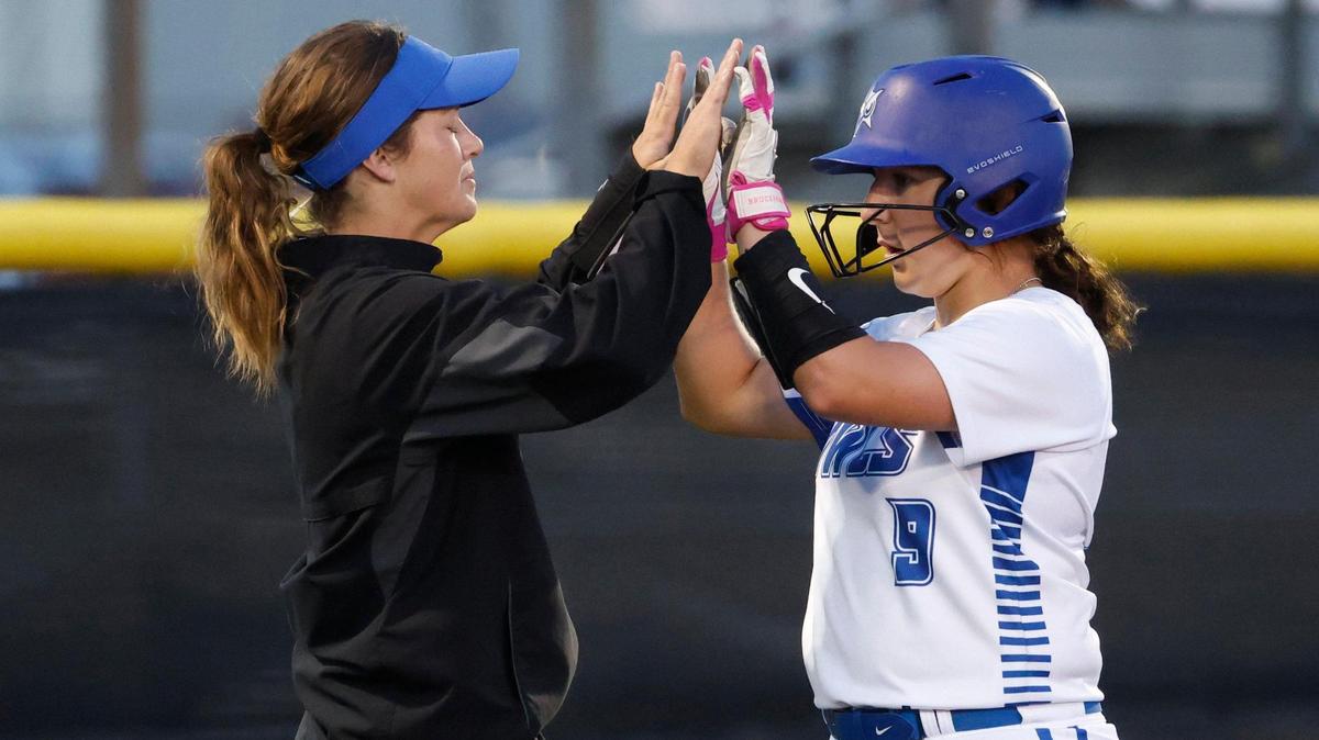 Joshua head coach Ashley Benson congratulates catcher Taylor Proffitt (9) after her triple drove in three runs during a UIL 5A D2 bi-district softball playoff game at Eagle Softball Field in Crowley, Texas, Thursday, Apr. 24, 2025.