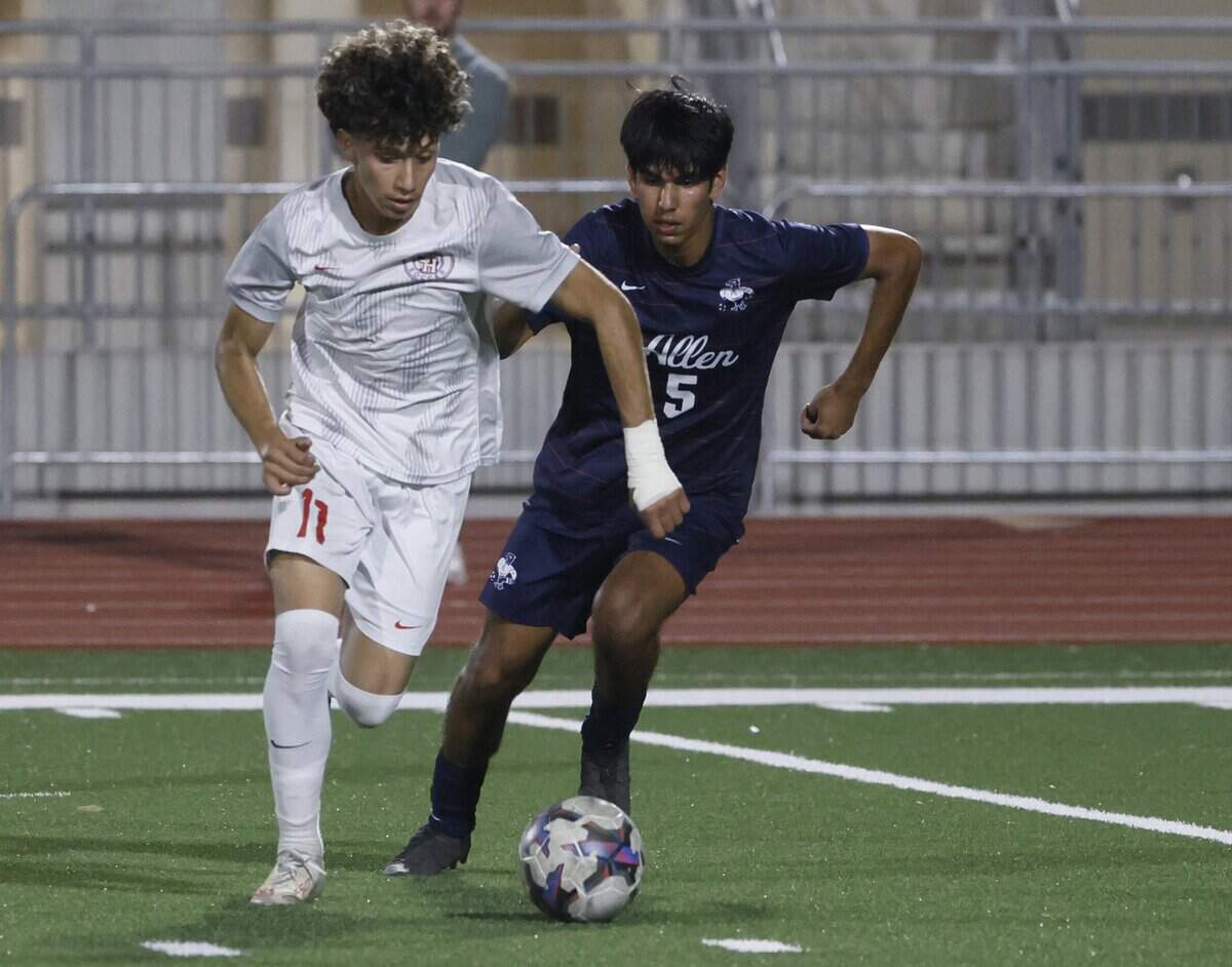 Arlington Sam Houston Edson Morin (11) and Allen midfielder Harsh Kumar (5) cross the pitch during the second half of a UIL area round boys soccer playoff game at Tommy Standridge Stadium in Carrollton, Texas, Tuesday, March 24, 2026.