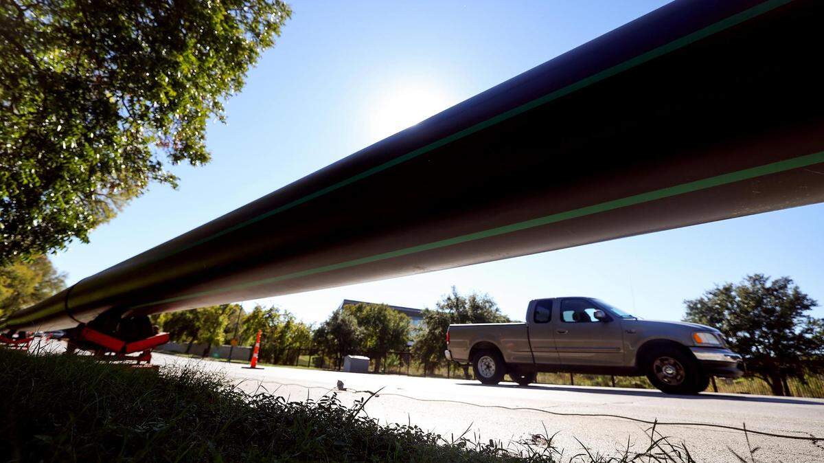 A large pipe runs along the northbound side of University Drive on Tuesday, October 17, 2023, in Fort Worth. The two right lanes were closed for construction from around Trinity Park Drive to Trail Drive.