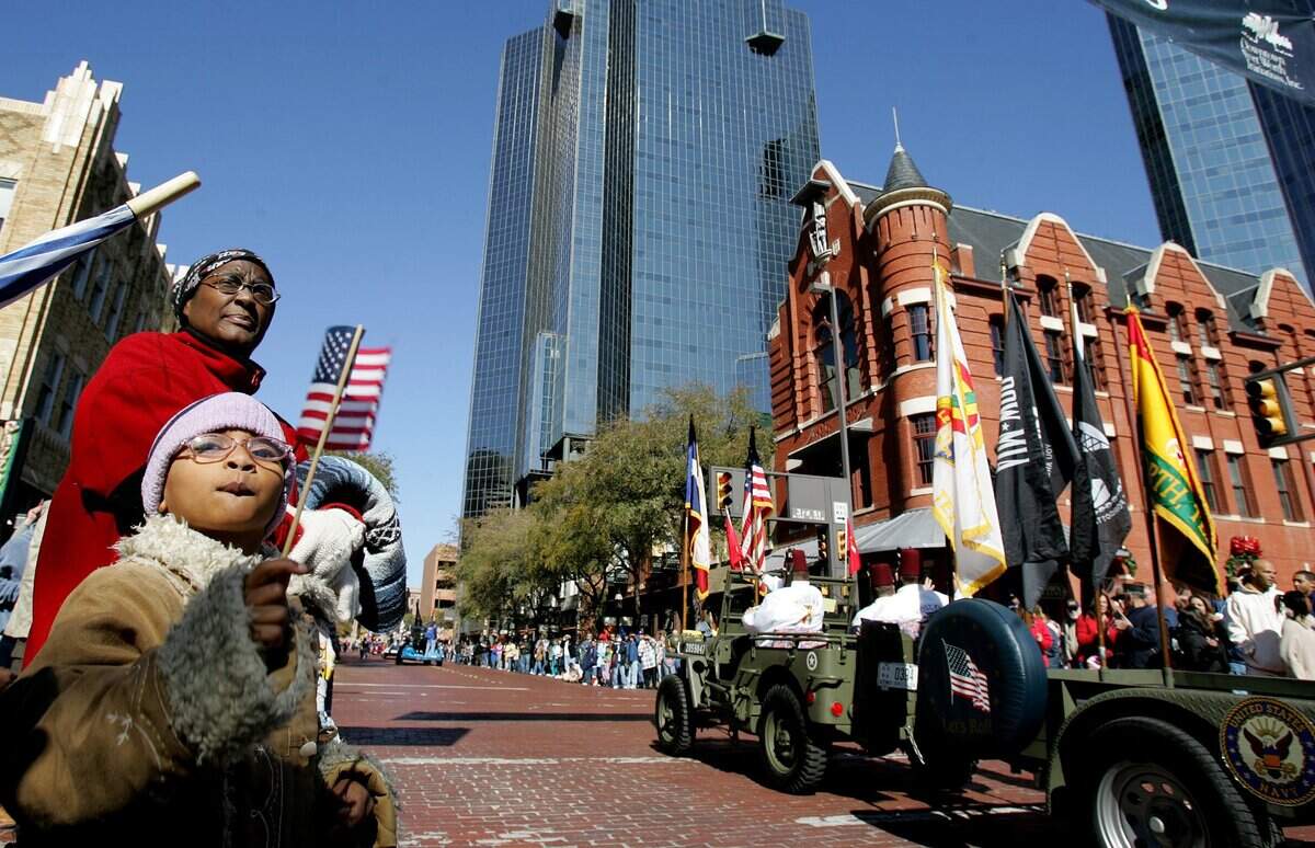 Nov. 11, 2006: Six-year-old Maia Green and her grandmother, Ada Haywood, watch the Veterans Day parade move along Main Street in downtown.