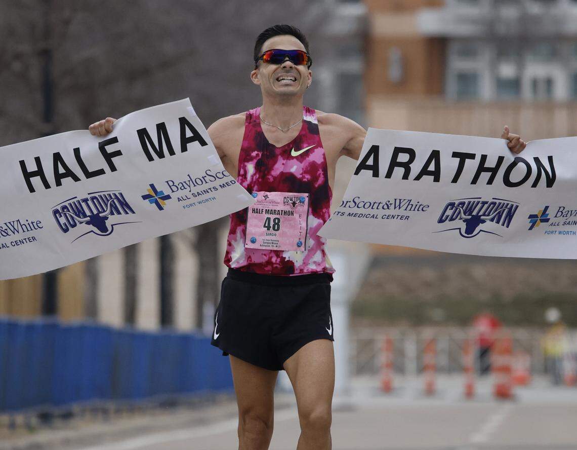 Sergio Mena does not cross the finish line in the traditional way, he ripped the banner apart by hand, during the 48th running of the Cowtown Marathon at the Will Rogers Memorial Center in Fort Worth, Texas, Sunday, Mar. 01, 2026.