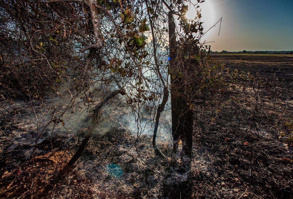 A fence post on a ranch along County Road 1005 in Somervell County is left smoldering on Wednesday, July 20, 2022. The Chalk Mountain fire ravaged ranches and scrubland near Glen Rose, damaging homes and vehicles left behind. The wildfire consumed more than 6,000 acres, forcing evacuations.