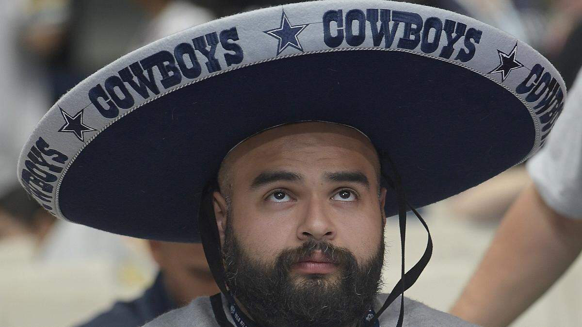 A Cowboys fan seems indifferent when a pick was announced by Dallas during the NFL Draft at AT&T Stadium in April.