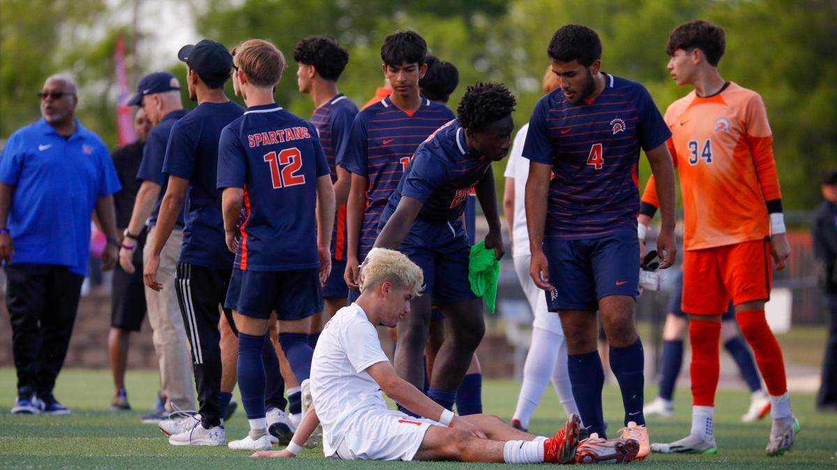 A Duncanville soccer player sits on the field following a loss to Katy Seven Lakes in a Class 6A state semifinal game at Birkelbach Field in Georgetown, Texas on April 12, 2024.