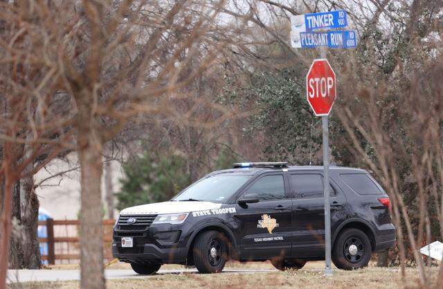 A state trooper blocks a section of Pleasant Run Road. Authorities northeast of Fort Worth are negotiating with a man who has apparently taken people hostage at a Colleyville, Texas synagogue during services. It is unclear if anyone is injured and how the man may be armed.
