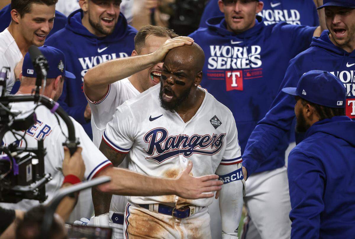 Texas Rangers right fielder Adolis Garcia celebrates with teammates after hitting a walk-off home run in the 11th inning during Game 1 of the World Series against the Arizona Diamondbacks on Friday, October 27, 2023, at Globe Life Field in Arlington.