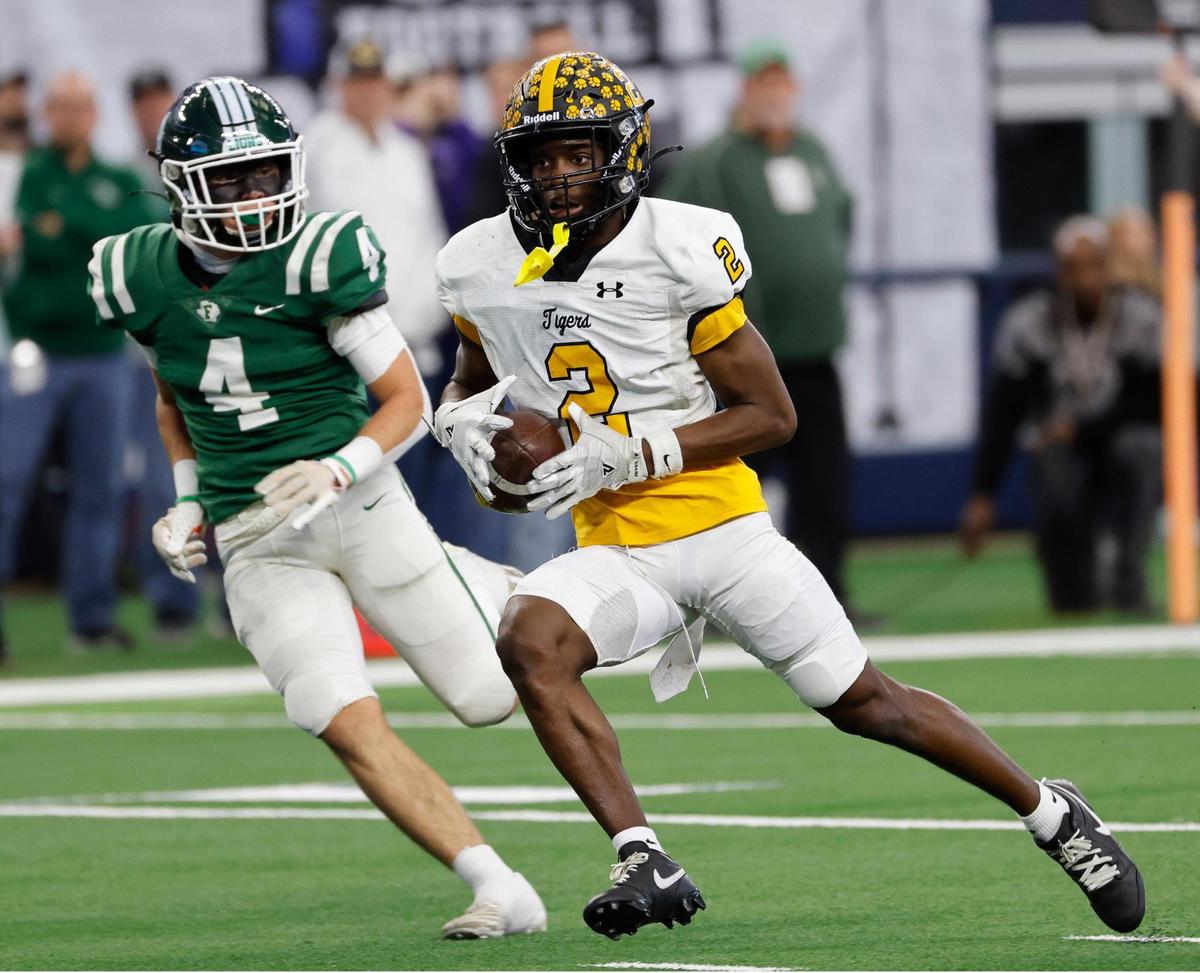 Malakoff wide receiver Chauncey Hogg (2) leads Franklin safety Noah Tart to the end zone for the only score of the first half of the UIL Conference 3A Division 1 state championship football game at AT&T Stadium in Arlington, Texas, Thursday, Dec. 14, 2023.
