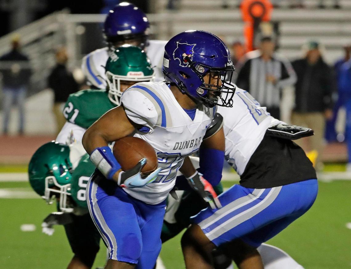 Dunbar running back Murry Moore (22) attacks the right side of the line in the first half of a District 6-4A D1 high school football game at Wildcat Stadium in Kennedale, Texas, Friday, Nov. 04, 2022. Kennedale led Dunbar 50-0 at the half. (Special to the Star-Telegram Bob Booth)
