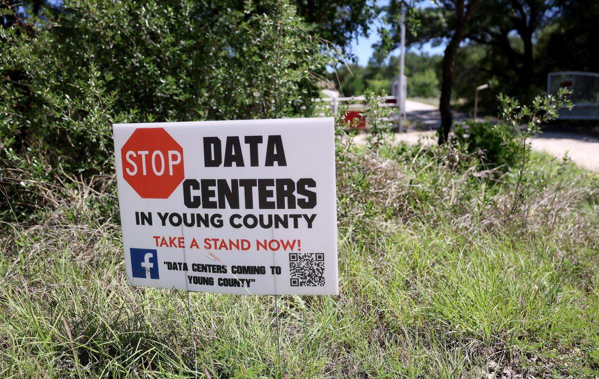 A sign opposing data centers stands in front of the entrance to Ryan Mote's land on Friday, April 24, 2026. 