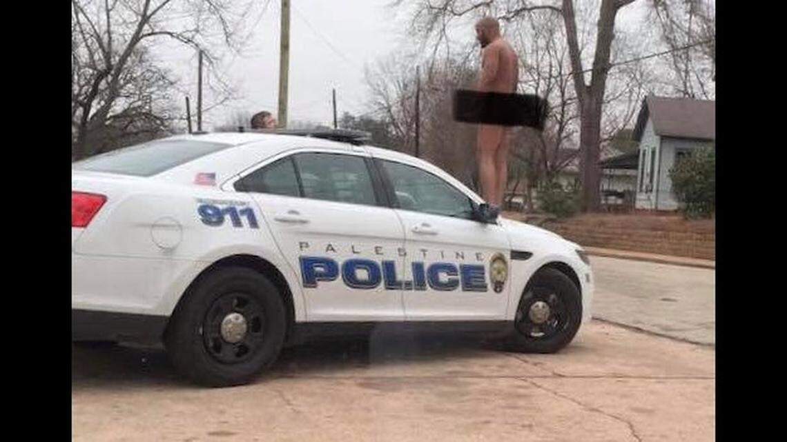 A man was arrested Monday in Palestine for hopping on a police car with no clothes on.