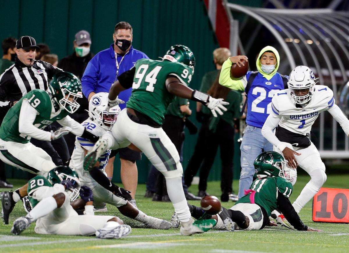 Arlington linebacker Trevor Bragg (19) recovers the Grand Prairie quarterback Michael Stallworth (1) fumble during a high school football game at Globe Life Park in Arlington Texas, Friday, Oct. 23, 2020. After two quarters of play Arlington led Grand Prairie 21-3.(Special to the Star-Telegram Bob Booth)