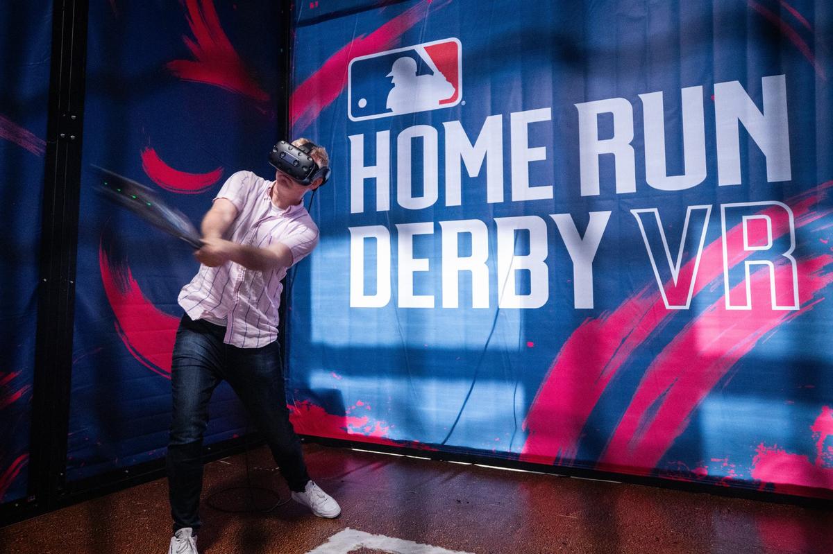 Bob Hearon gives a demonstration on a virtual reality headset during the Capital One All-Star Village hard hat tour on Thursday, July 11 at Esports Stadium in Arlington. The VR simulated the batter’s box at Globe Life Field with a specially built bat to hit as many home runs as you can in 90 seconds.