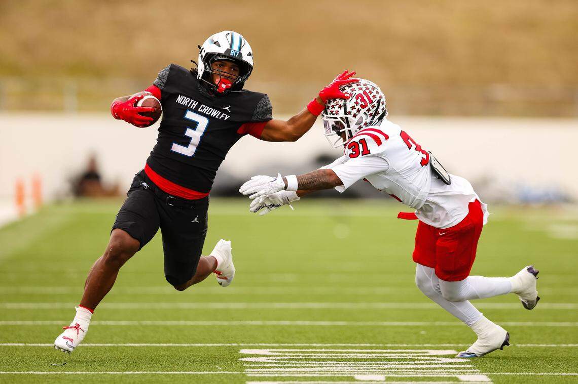 North Crowley running back G'Yrell Smith stiff-arms Coppell cornerback Isaiah Witherspoon (31) while running with the ball in a Class 6A Division I regional playoff Saturday, Nov. 29, 2025, at Midlothian ISD Stadium in Midlothian.