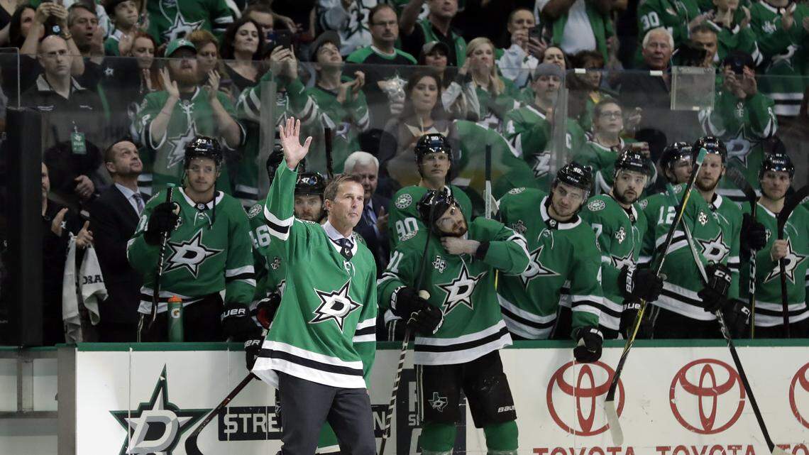 Former Dallas Stars player Mike Modano acknowledges cheers from fans during Saturday's pregame ceremony where Modano was honored before a game against the Minnesota Wild in Dallas.