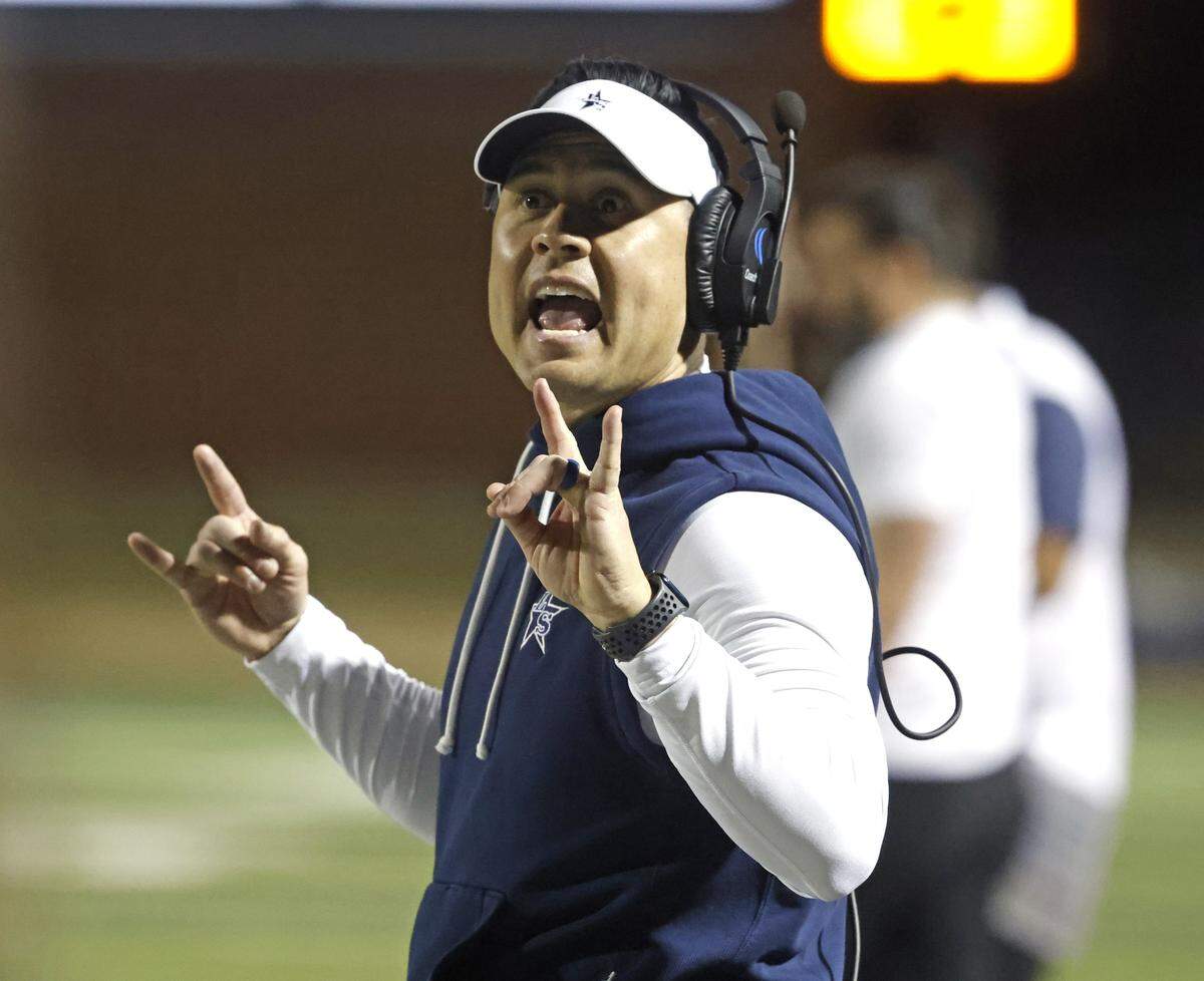 Frisco Lone Star head coach Jeff Rayburn sends in a play against Aledo during the first half of a UIL Class 5A Division I Semifinal on Friday Dec. 12, 2025 at Vernon Newsom Stadium in Mansfield, Texas.