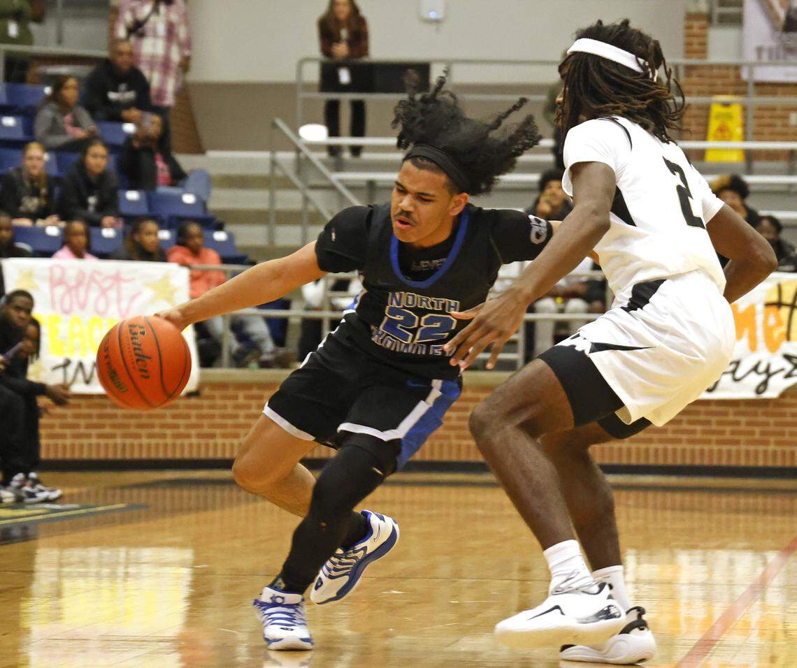 North Crowley guard Isaak Hayes (22) commits a turnover against Mansfield's Zion Robinson (2) during the first half of a UIL boys basketball game between North Crowley and Mansfield at Mansfield High School in Mansfield, Texas, Tuesday Jan. 20, 2026