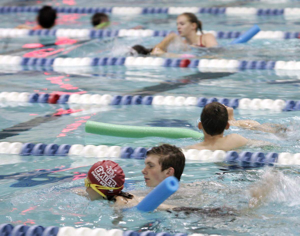 Younger and less experienced swimmers were accompanied by safety swimmers from the Keller High School swim team during the Keller Kids and Family Triathlon at the Keller Natatorium on April 10, 2016.