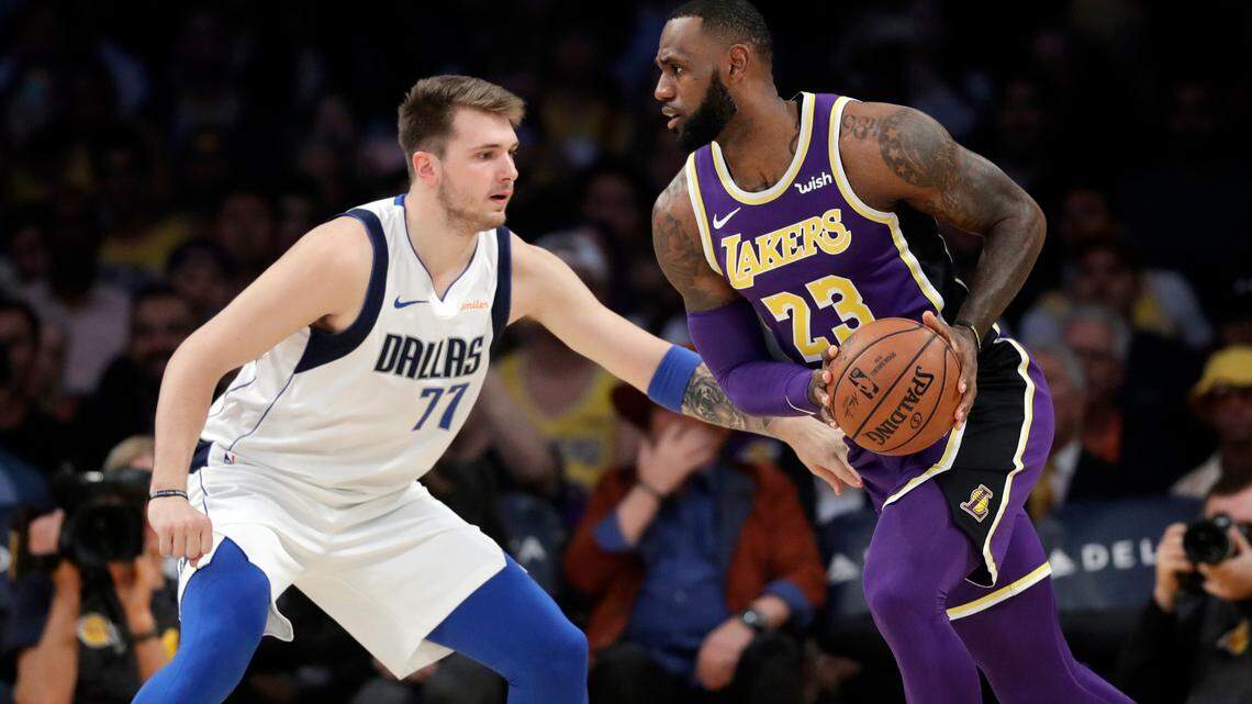 Los Angeles Lakers’ LeBron James (23) is defended by Dallas Mavericks’ Luka Doncic (77) during the first half of an NBA basketball game Wednesday, Oct. 31, 2018, in Los Angeles. (AP Photo/Marcio Jose Sanchez)