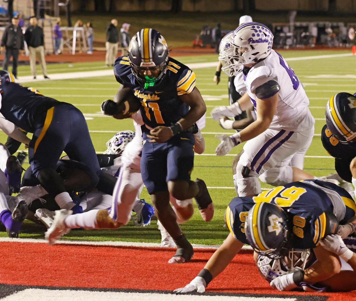 Arlington Heights quarterback Kaeden Grant (11) gets in the end zone for six during the Battle of the Bonfire UIL District 4-5A D1 football game at Farrington Field in Fort Worth, Texas, Friday, Nov. 08, 2024.