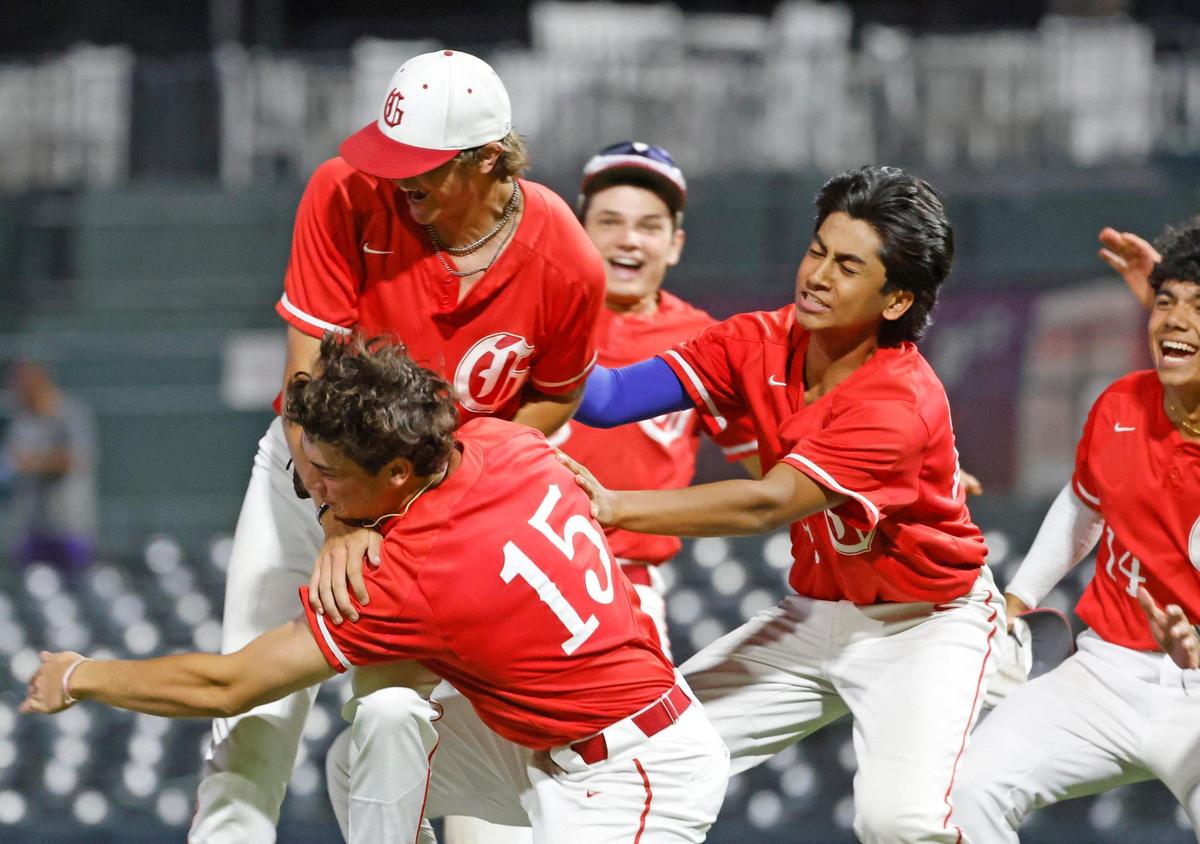 Grapevine players tackle pitcher Sam DuRard (13) after he closed out the game during a UIL 5A D2 semifinal baseball game at Riders Park in Frisco, Texas, Friday, May 30, 2025.