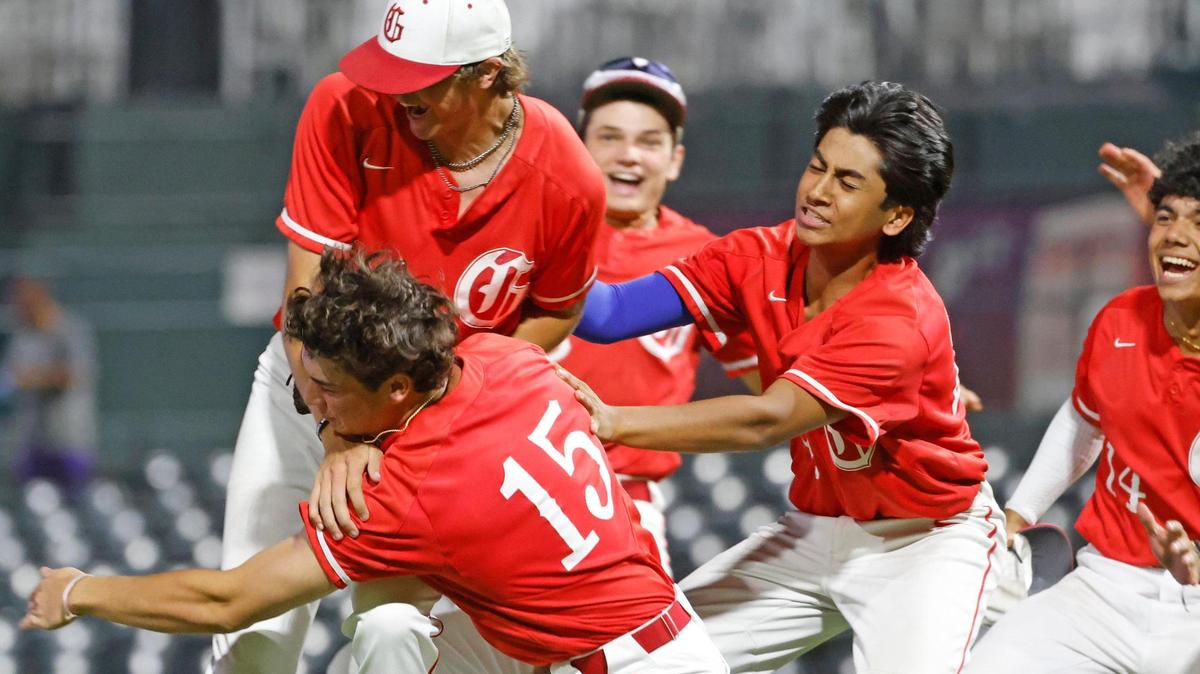 Grapevine players tackle pitcher Sam DuRard (13) after he closed out the game during a UIL 5A D2 semifinal baseball game at Riders Park in Frisco, Texas, Friday, May 30, 2025.