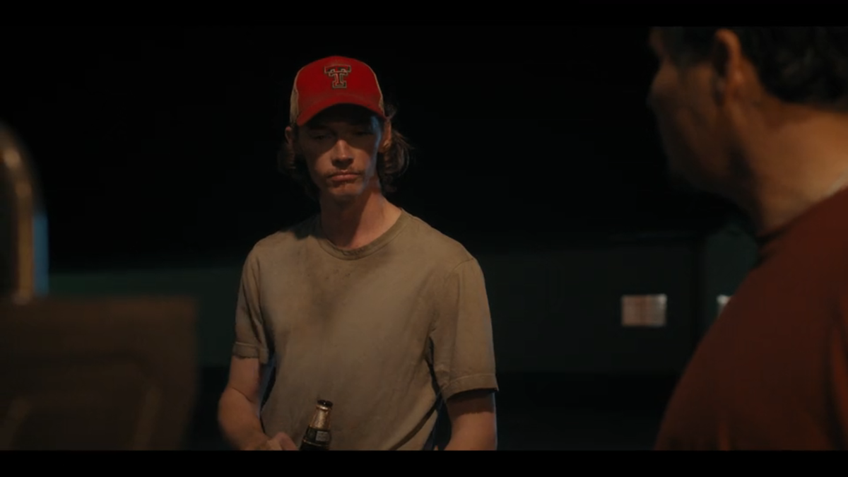 (L to R) Cooper Norris (Jacob Lofland) speaks to Armando (Michael Peña) in “Landman” episode 1.
