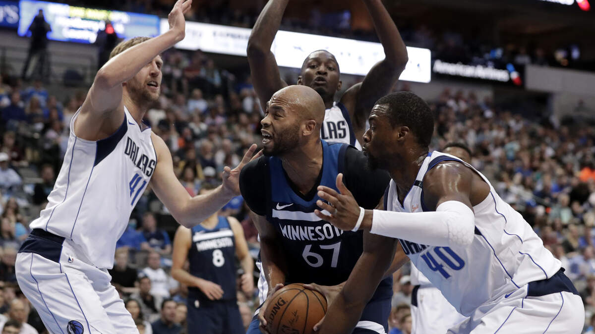 Minnesota Timberwolves forward Taj Gibson (67) is surrounded by Dallas Mavericks' Dirk Nowitzki, left, Dorian Finney-Smith, rear, and Harrison Barnes (40) in the first half of Friday's NBA game in Dallas.
