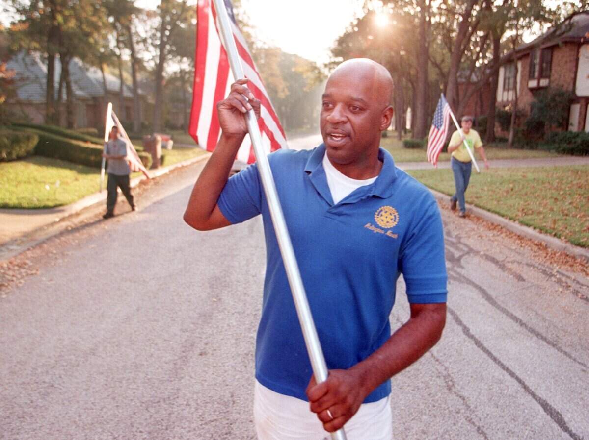 Nov. 11, 1999: Vernell Carter II leads the procession as he walks to the next house on his group’s list. Members of Arlington North Rotary Club set out flags in North Arlington neighborhoods for Veterans Day. Behind Carter are Nick Miranda and Dr. Wayne Koski.