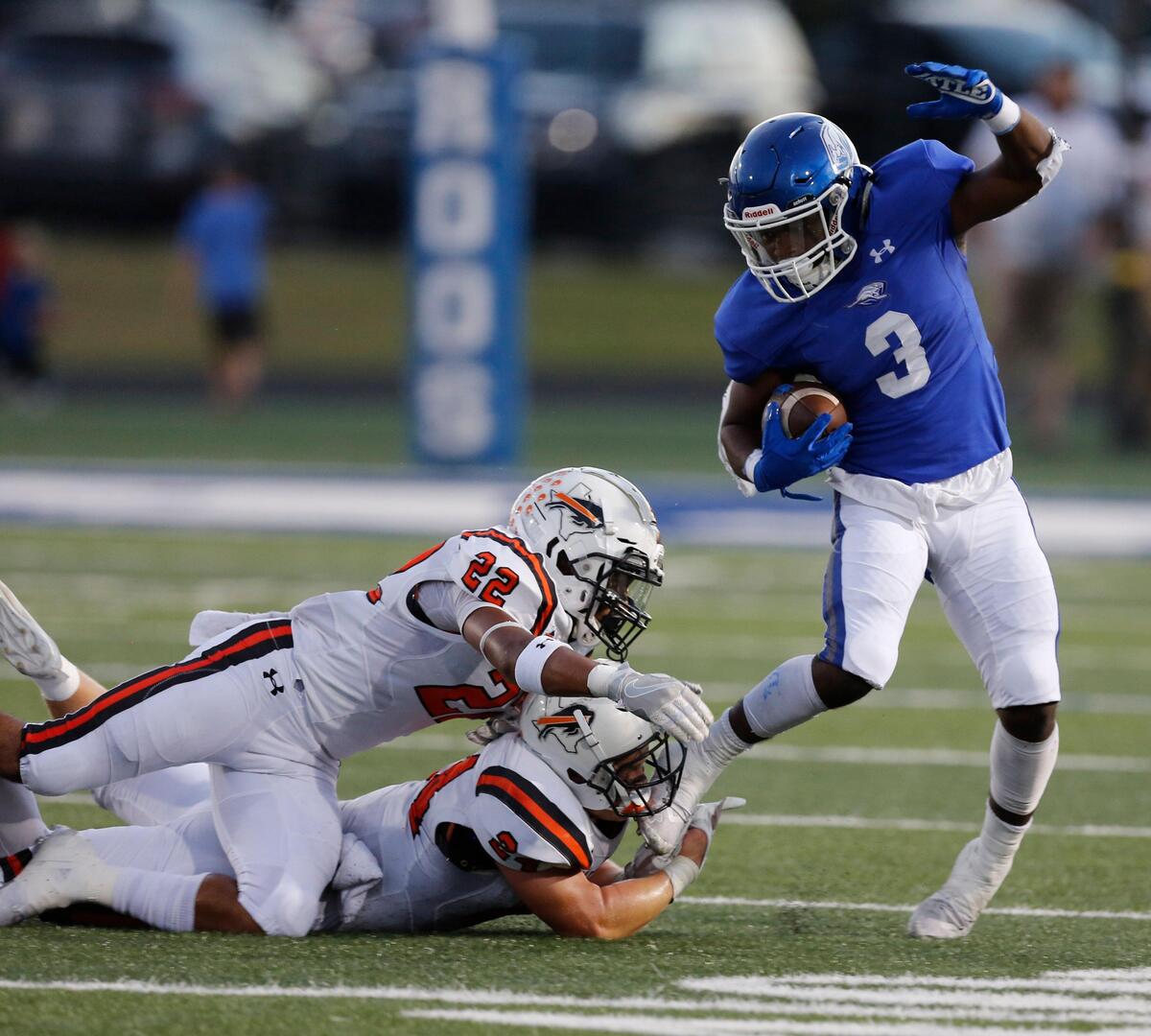 Weatherford’s Dezmond Forrest (3) dances away from Haltom’s Johnny Smith-Rider (22) and Brandon Thammavong(9) on a run in the first half. The Haltom Buffalos played the Weatherford Kangaroos at Kangaroo Stadium in Weatherford Thursday, Oct. 3, 2019.