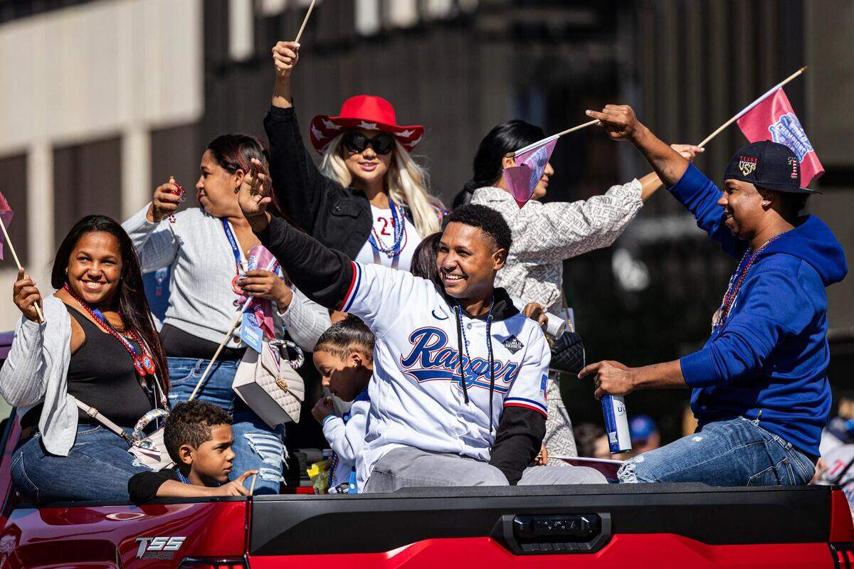 Rangers pitcher Jose Leclerc celebrates with his family and the crowd for the World Series Parade in front of Globe Life Field in Arlington on Friday, Nov. 3, 2023.