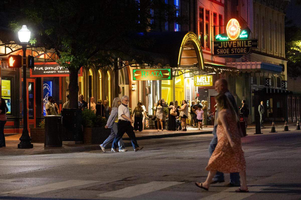 People walk across Houston Street as others wait in front of Melt Ice Creams on Saturday, May 7, 2022, in downtown Fort Worth.