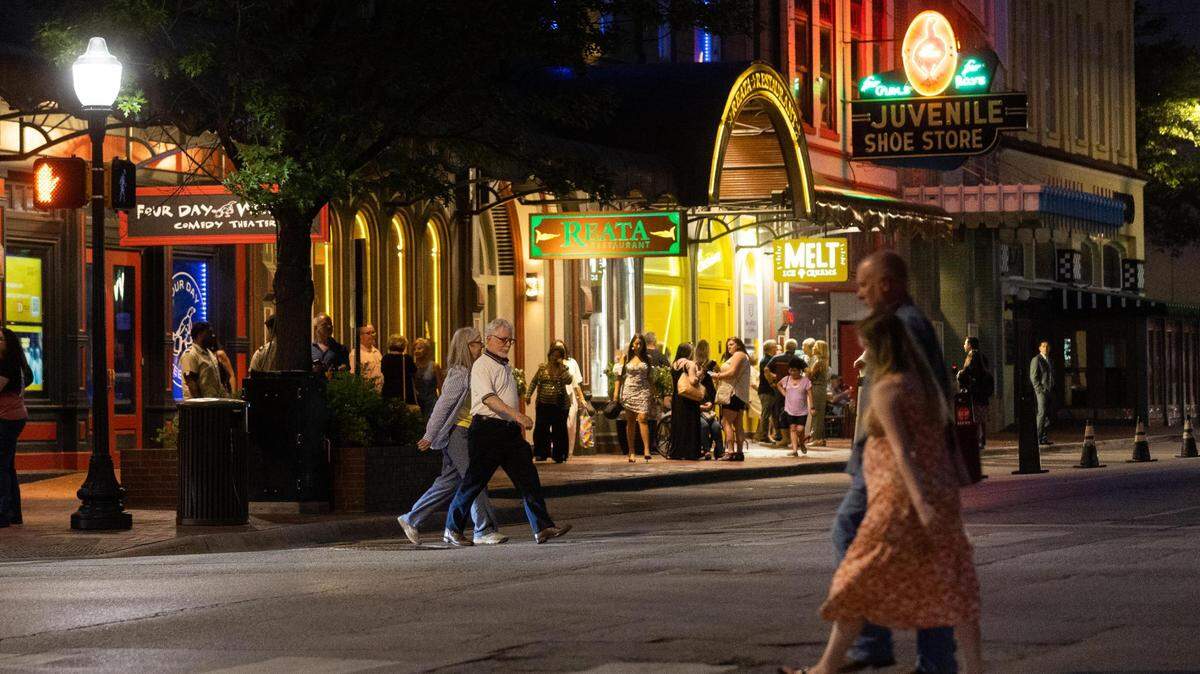 People walk across Houston Street as others wait in front of Melt Ice Creams on Saturday, May 7, 2022, in downtown Fort Worth.
