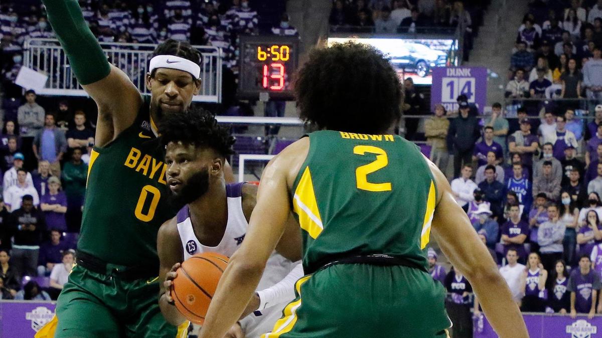 TCU guard Mike Miles (1) drives to the net between the defense of Baylor forward Flo Thamba (0) and guard Kendall Brown (2) during the second half of a NCAA basketball game at Schollmaier Arena in Fort Worth, Texas, Saturday, Jan. 08, 2022. The Baylor Bears defeated the TCU Horned Frogs 76-64. (Special to the Star-Telegram Bob Booth)