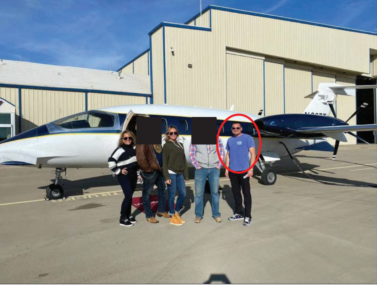Jason Hyland (circled), Jenna Ryan and Katie Schwab, three Dallas-Fort Worth real estate agents, have been charged in connection to the insurrection at the U.S. Capitol on Jan. 6. The three took a group photo at US Trinity Aviation in Denton before boarding a private plane to D.C., according to the FBI.